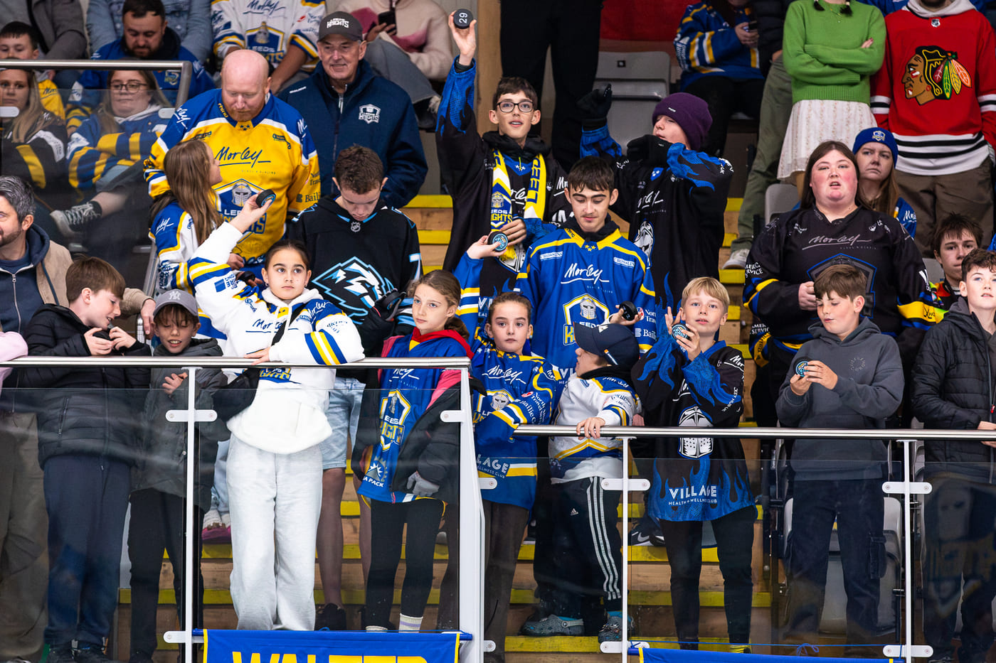 more children playing chuck-a-puck at a Leeds Knights game